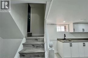 Hamilton apartment for rent - A staircase with wooden steps and a black door at the top.