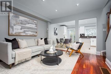 Mississauga (Streetsville) townhouse for rent - A living room with a grey couch, a coffee table, and a painting on the wall.