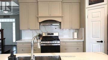 London North (North C) apartment for rent - A kitchen with a stove top oven and a sink.