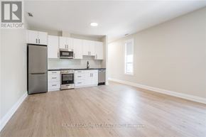 Hamilton (Raleigh) apartment for rent - A kitchen with white cabinets and a wooden floor.