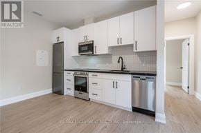 Hamilton (Raleigh) apartment for rent - A kitchen with white cabinets and stainless steel appliances.