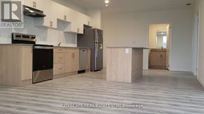 Guelph (Willow West/Sugarbush/West Acres) condo for rent - A realtor logo is on the wall above a kitchen island.