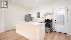 Brantford townhouse for rent - A white kitchen with a large island and stainless steel appliances.