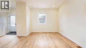 Brantford townhouse for rent - A room with wooden floors and a window.