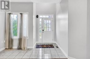 Bradford West Gwillimbury (Bradford) apartment for rent - A hallway with a door and a window with curtains.