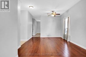 Bradford West Gwillimbury (Bradford) apartment for rent - A room with wooden floors and a ceiling fan.