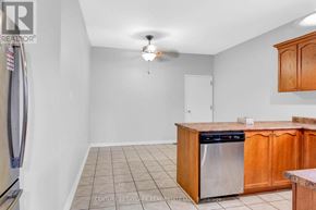 Bradford West Gwillimbury (Bradford) apartment for rent - A kitchen with wooden cabinets and a tile floor.