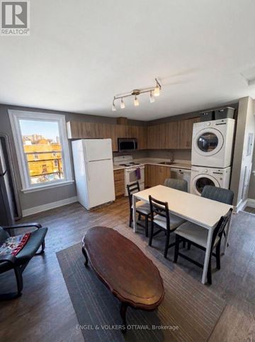 Ottawa apartment for rent - A kitchen with a table and chairs in front of a window.