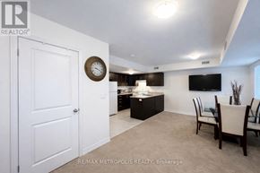 Asphodel-Norwood (Norwood) townhouse for rent - A living room with a white door and a clock on the wall.