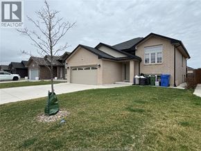 Windsor apartment for rent - A house with a brown roof and a green lawn in front.