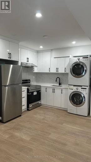 Toronto (Weston) apartment for rent - A modern kitchen with wooden floors and stainless steel appliances.