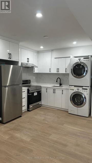 Toronto (Weston) apartment for rent - A modern kitchen with wooden floors and stainless steel appliances.