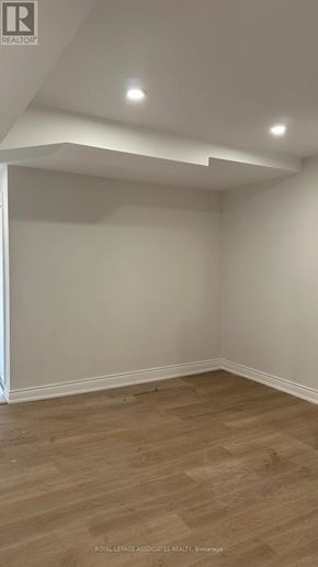 Toronto (Weston) apartment for rent - A room with wooden flooring and white walls.