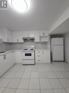 Toronto (Agincourt North) apartment for rent - A white kitchen with a stove, oven, and refrigerator.