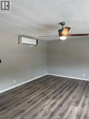 Tecumseh apartment for rent - A room with a ceiling fan and an air conditioner unit.