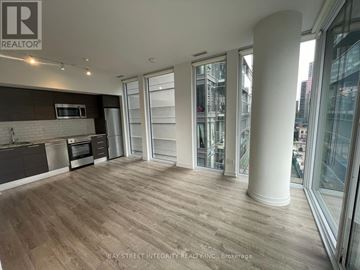 Toronto (Church-Yonge Corridor) condo for rent - A spacious kitchen with wooden flooring and a large island.