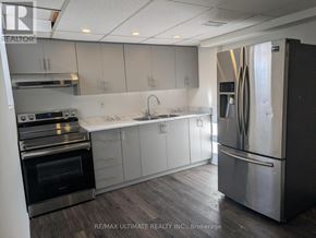 Pickering (Woodlands) apartment for rent - A modern kitchen with stainless steel appliances and white cabinets.