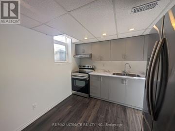 Pickering (Woodlands) apartment for rent - A kitchen with a refrigerator on the right side.