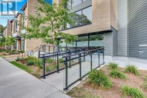 Toronto (West Hill) condo for rent - A modern building with a glass railing and a tree in front.