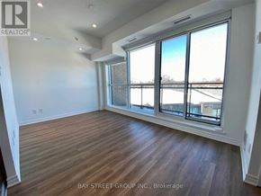 Toronto (West Hill) condo for rent - A room with a large window and wooden flooring.