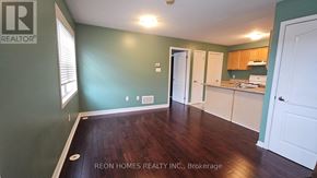 Markham (Cornell) apartment for rent - A room with green walls and wooden floors.
