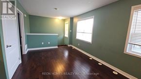 Markham (Cornell) apartment for rent - A room with green walls and wooden floors.