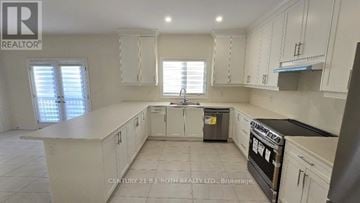 Oro-Medonte (Sugarbush) apartment for rent - A kitchen with white cabinets and a black oven.