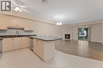 Lasalle condo for rent - A kitchen with wooden cabinets and a black countertop.