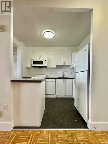 Toronto (University) condo for rent - A kitchen with white cabinets and appliances.