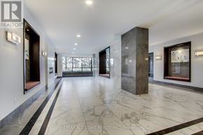 Toronto (Steeles) condo for rent - A hallway with marble floors and a column in the middle.