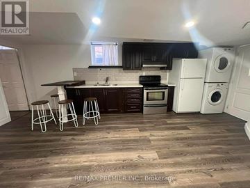 Vaughan (Maple) apartment for rent - A kitchen with dark wood floors and white appliances.