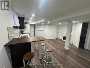 Vaughan (Maple) apartment for rent - A modern kitchen with a bar area and wooden flooring.