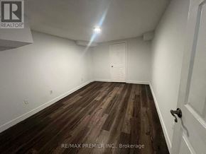 Vaughan (Maple) apartment for rent - A room with wooden flooring and a white door.