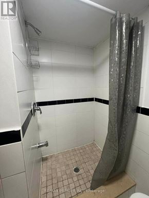 Vaughan (Maple) apartment for rent - A white bathroom with a shower curtain and a toilet.