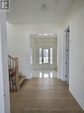 Oro-Medonte apartment for rent - A long hallway with a staircase on the left and a door on the right.