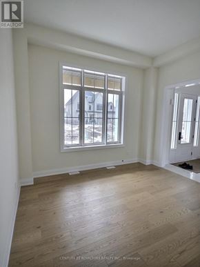 Oro-Medonte apartment for rent - A room with a large window and wooden flooring.