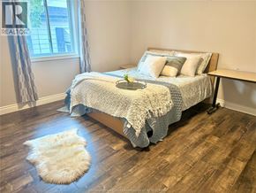 Windsor apartment for rent - A bedroom with a large bed and a window.