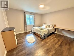 Windsor apartment for rent - A bathroom with a toilet, sink, and shower curtain.