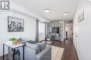 Guelph (Grange Road) townhouse for rent - A living room with a grey couch and a coffee table.