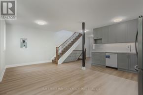 Toronto (Kensington-Chinatown) apartment for rent - A spacious room with a staircase leading to the upper floor.