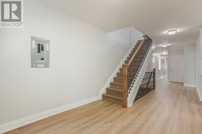 Toronto (Kensington-Chinatown) apartment for rent - A spacious hallway with a staircase and a wall-mounted elevator control panel.