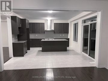 Brampton (Credit Valley) apartment for rent - A modern kitchen with dark brown cabinets and a central island.