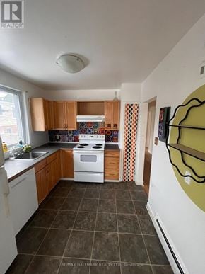 Toronto (Woodbine Corridor) triplex for rent - A kitchen with white appliances and brown cabinets.