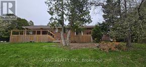 Brampton (Credit Valley) apartment for rent - A house with a deck and a tree in front of it.