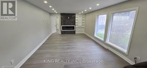 Brampton (Credit Valley) apartment for rent - A spacious room with a large window and a door in the background.