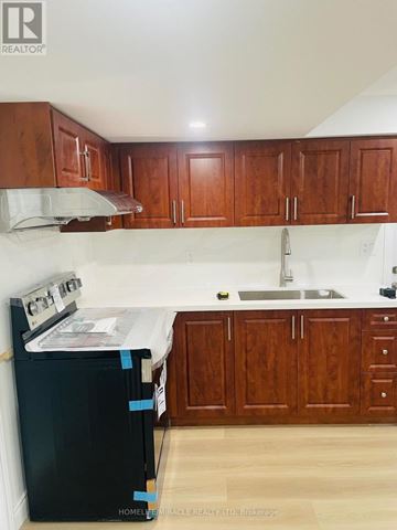 Oakville (Wm Westmount) apartment for rent - A kitchen with wooden cabinets and a black dishwasher.