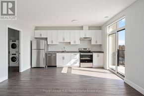 Tillsonburg multi-family for rent - A modern kitchen with white cabinets and stainless steel appliances.