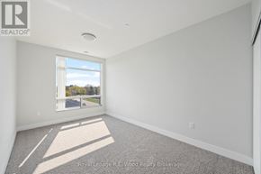 Tillsonburg multi-family for rent - A well lit empty room with a window and carpet on the floor.