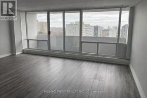 Toronto (Dorset Park) condo for rent - A room with a large window and wooden flooring.