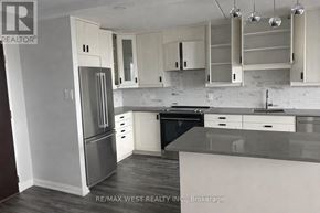 Toronto (Dorset Park) condo for rent - A kitchen with white cabinets and a black dishwasher.